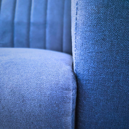 Navy blue fabric two-seater sofa on rent, featuring a sleek modern design with textured upholstery in a comfortable living room setting.